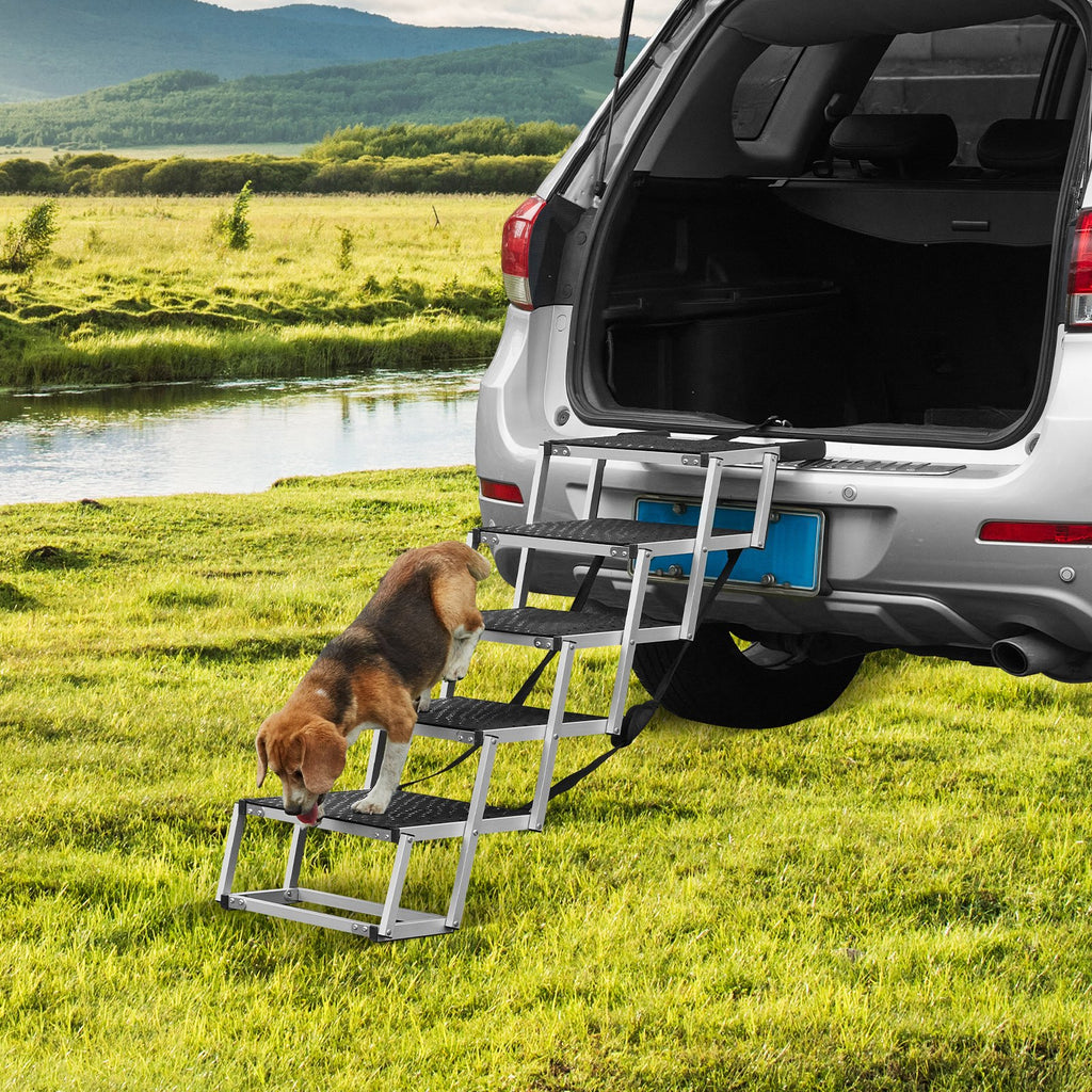Dog walking up folding car stairs into an SUV outdoors