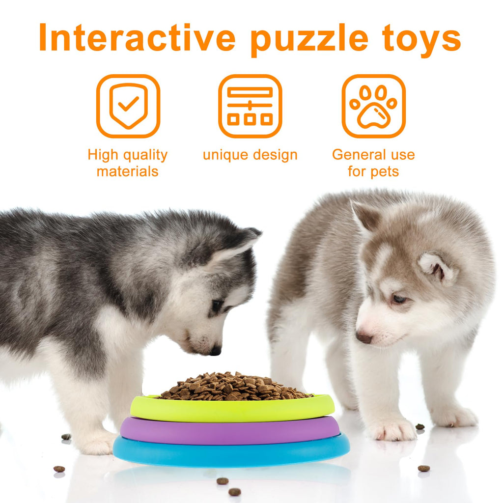 Two husky puppies eating from a rotating dog puzzle feeder