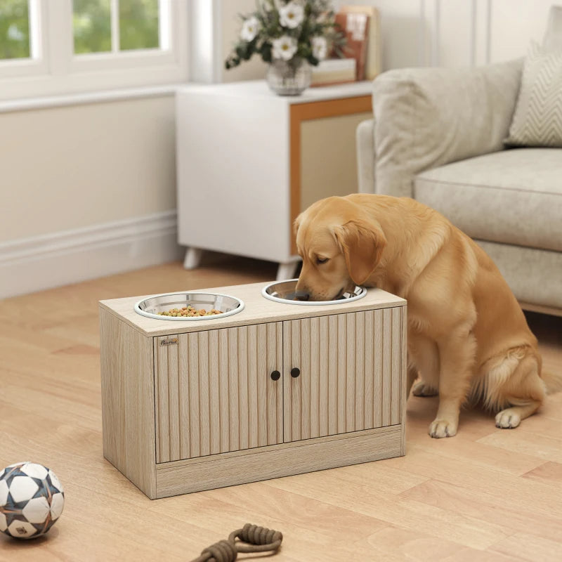 Golden retriever eating from a light wood raised dog bowl stand