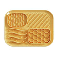 Top view of yellow silicone lick mat showing textured zones and honeycomb pattern