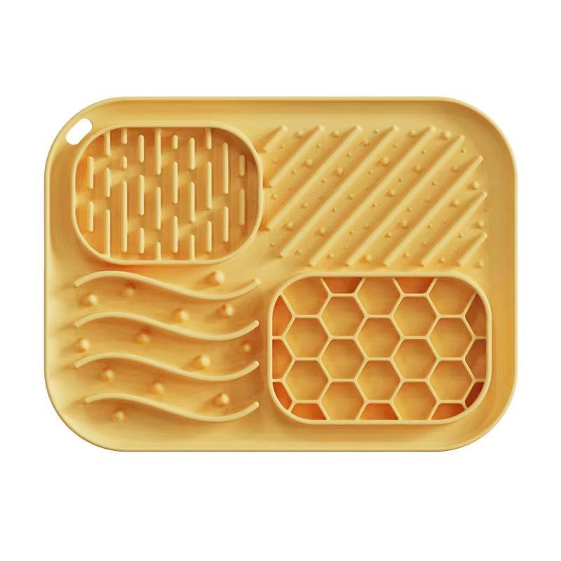 Top view of yellow silicone lick mat showing textured zones and honeycomb pattern